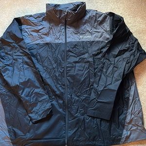 Black and grey rain jacket with rolled up hood. Columbia. Size 4XL tall.